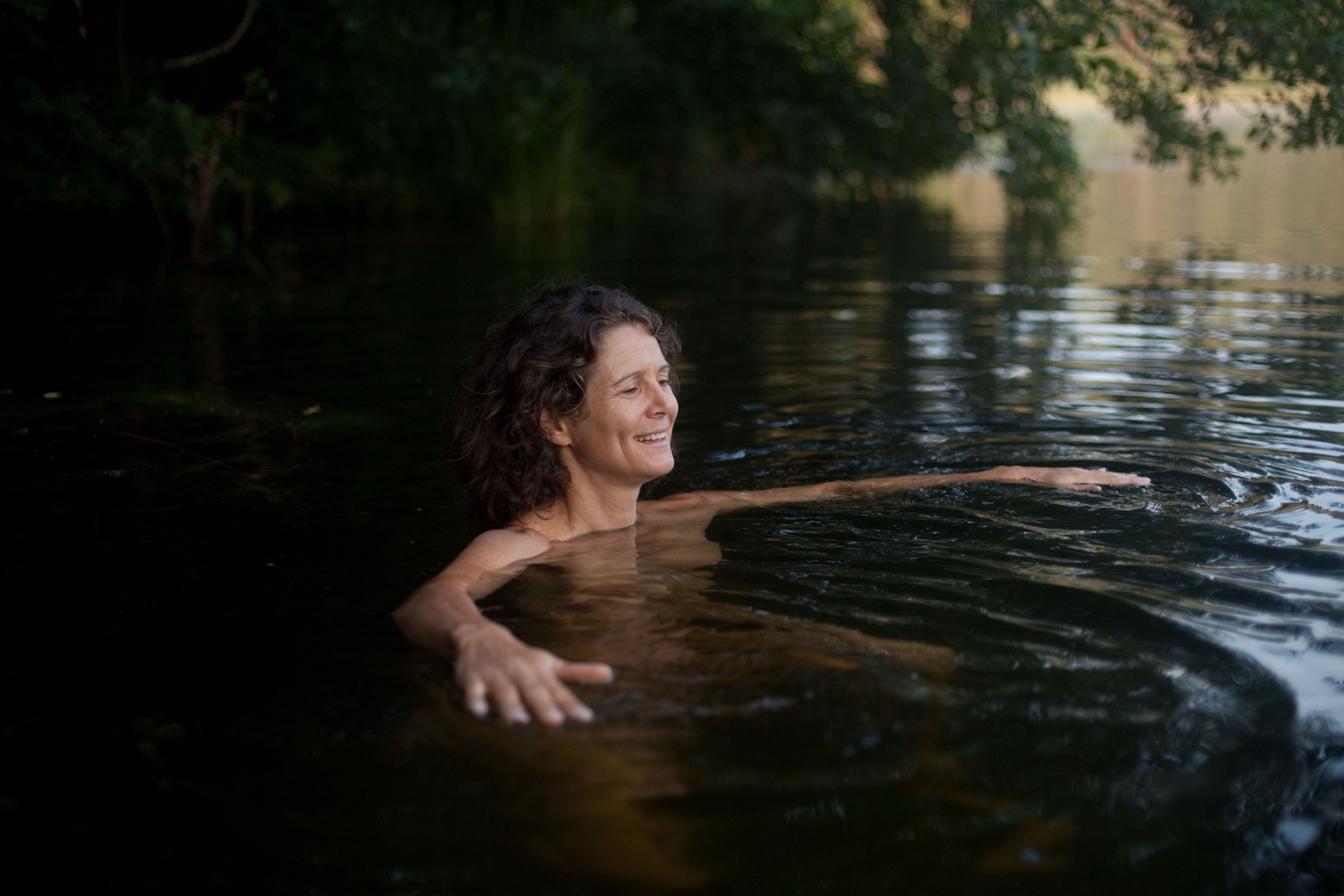 Christina smiling in dark water